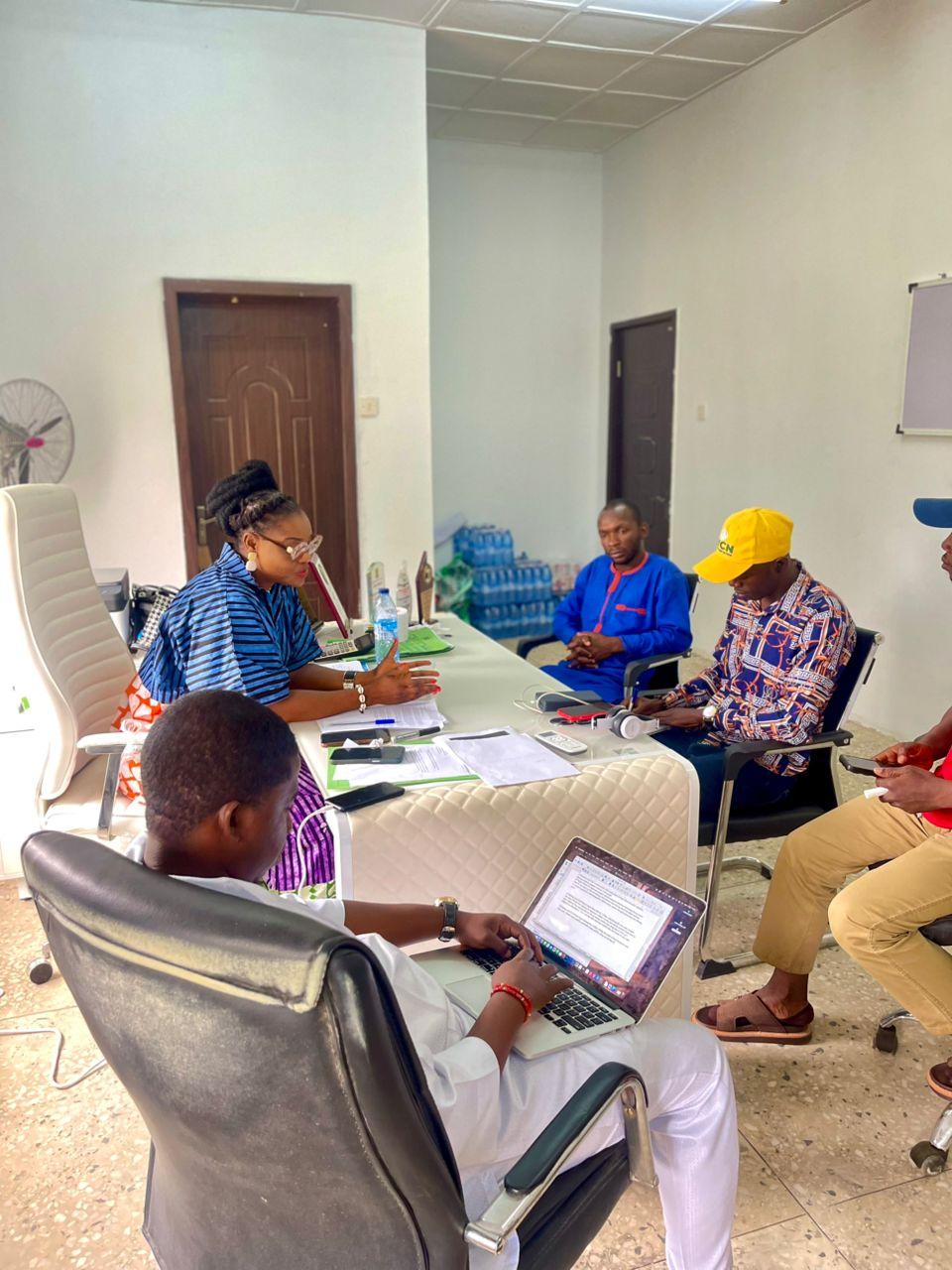 Business professionals shaking hands in an office meeting room, representing partnership and collaboration on Osun State climate action programmes