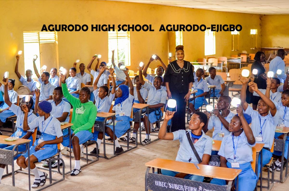 Wide view of students at Agurodo High School Agurodo-Ejigbo raising their solar lanterns in celebration after distribution by Osun State climate office