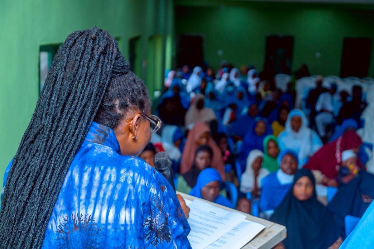 Prof. Chinwe Obuaku-Igwe speaking to a packed hall of students at a school climate awareness and green education workshop in Osun State
